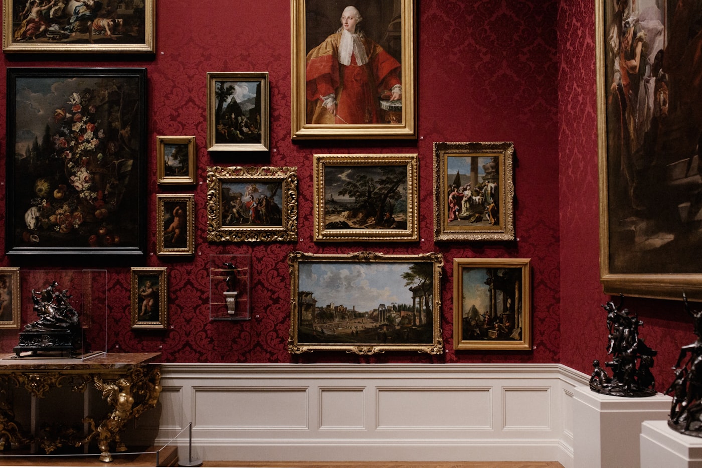 A salon-style gallery wall densely hung with framed artworks.